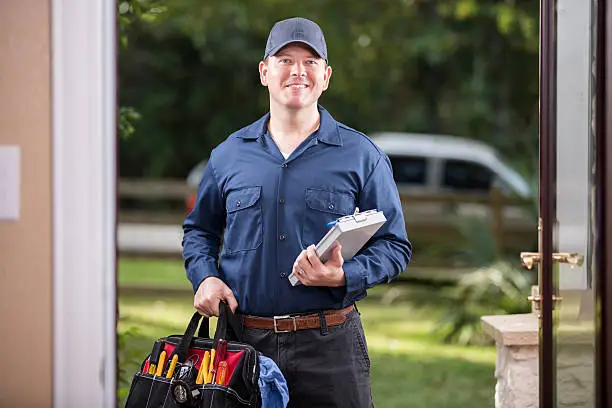 Smiling technician ready for mosquito elimination system maintenance service